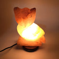 Hand-carved Himalayan salt owl lamp glowing warm amber