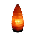 Ice cone shaped Himalayan salt lamp with a ridged surface, lit from within