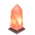 Hand-carved Himalayan salt obelisk lamp glowing warm