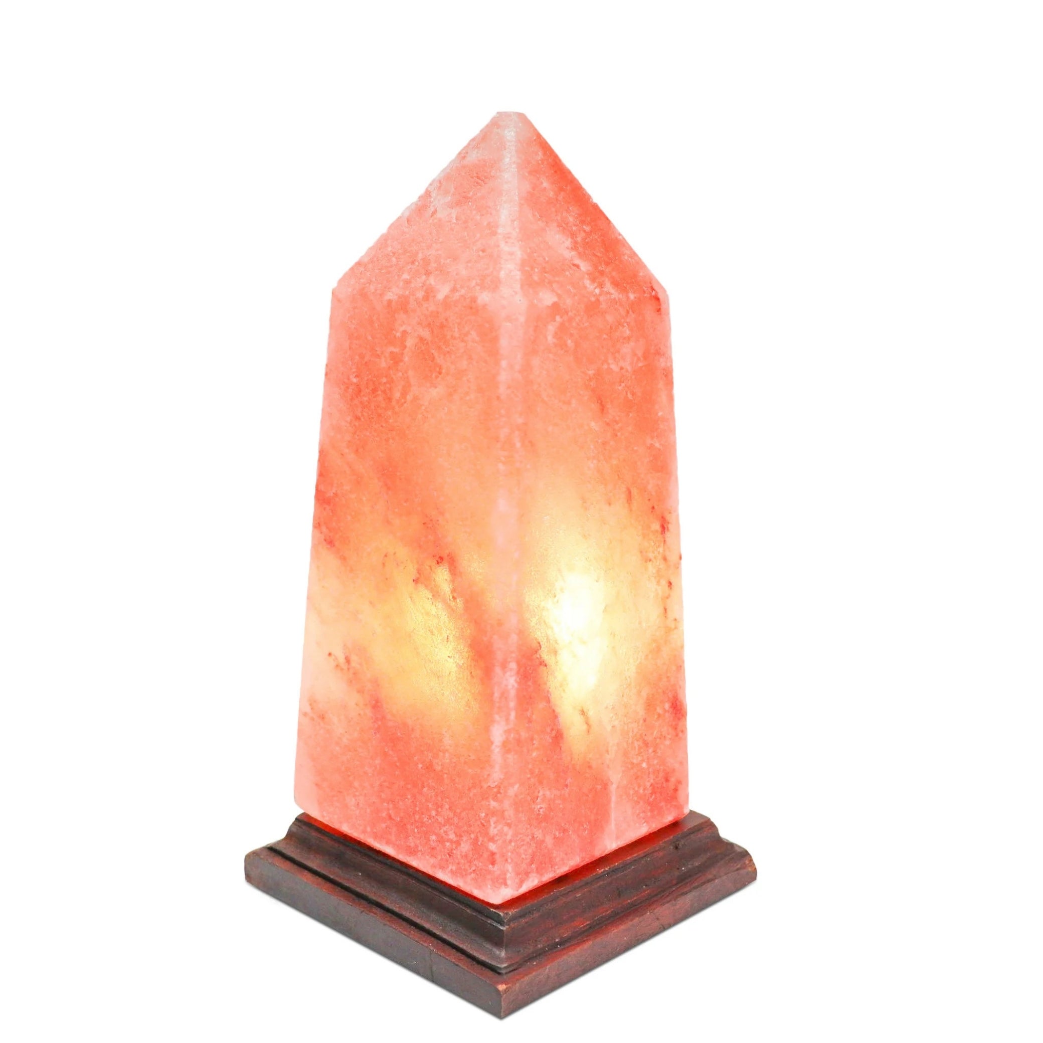 Hand-carved Himalayan salt obelisk lamp glowing warm
