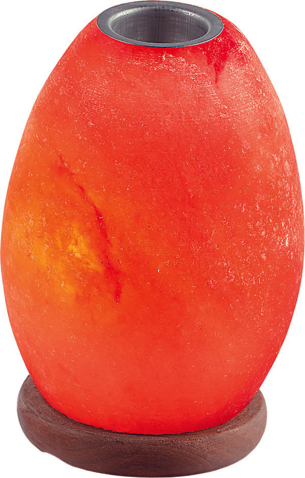 Hand-carved salt egg oil burner glowing amber with an oil dish