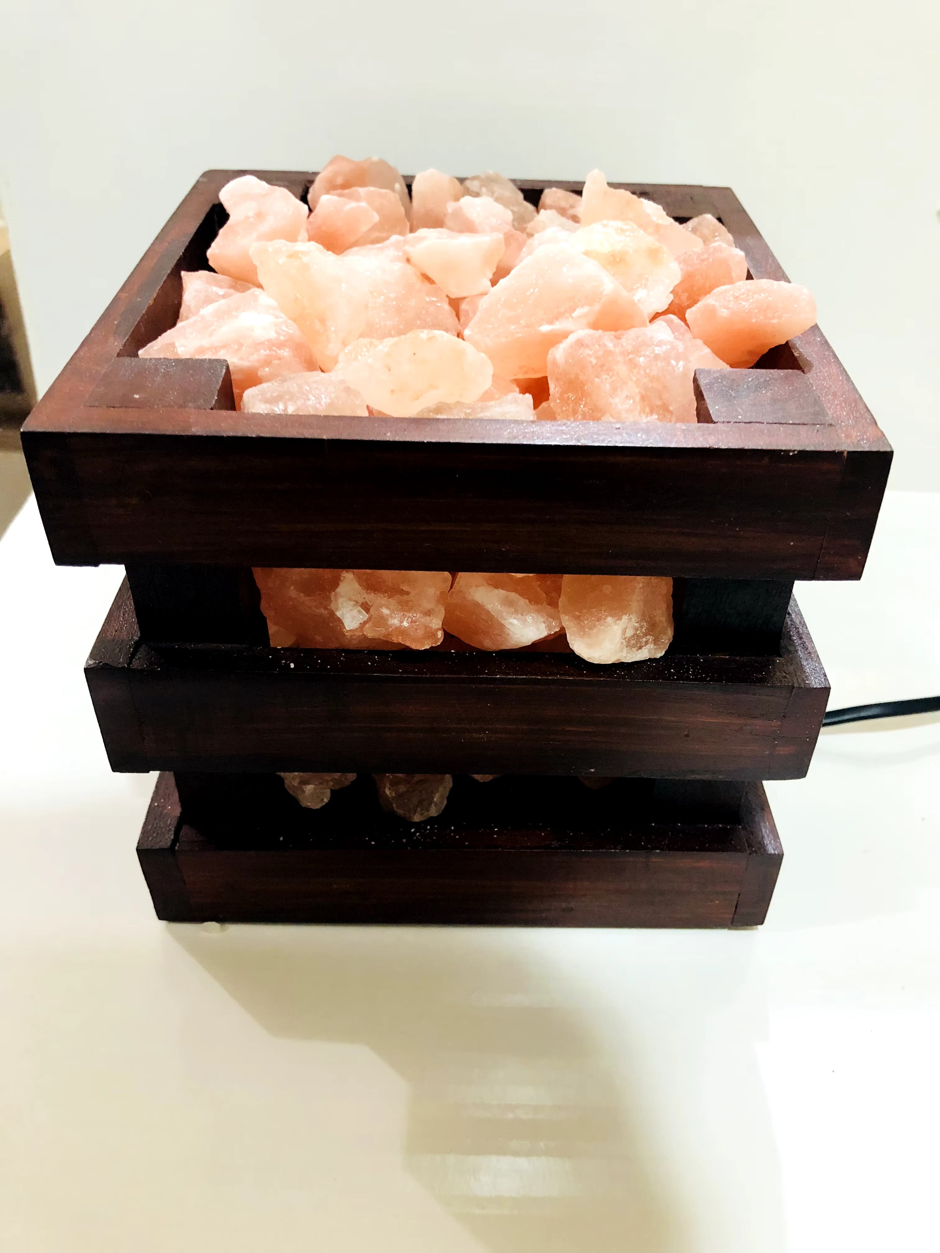 Wooden basket Himalayan salt lamp filled with glowing salt chunks