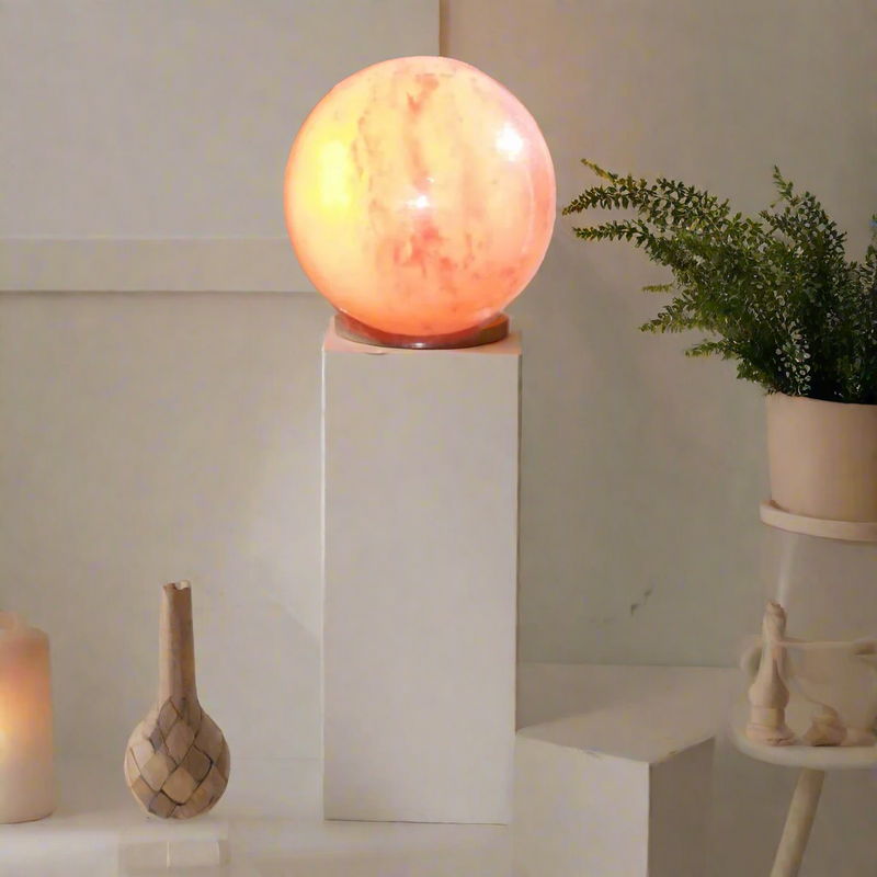Himalayan salt sphere lamp raised on a tall stand